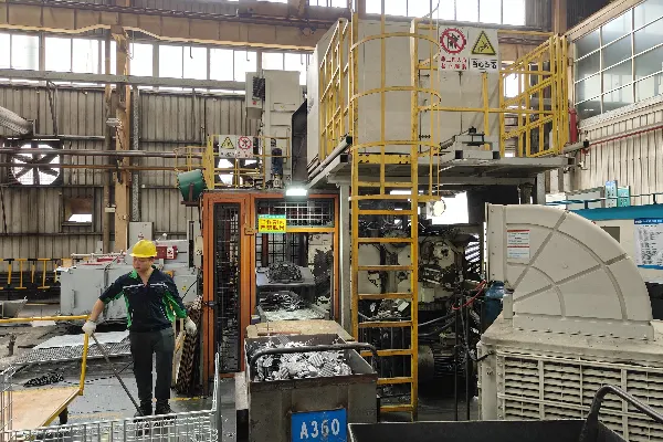 A fast-cycling die casting machine ejecting a newly formed part