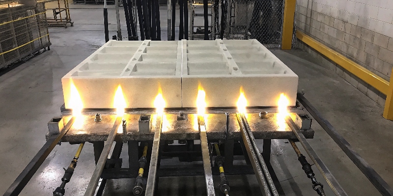 A large die casting mold being preheated with external gas torch heaters.