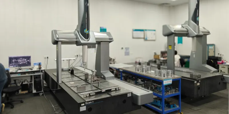 A CMM machine measuring a complex aluminum die-cast part, with a digital readout showing tolerance measurements.