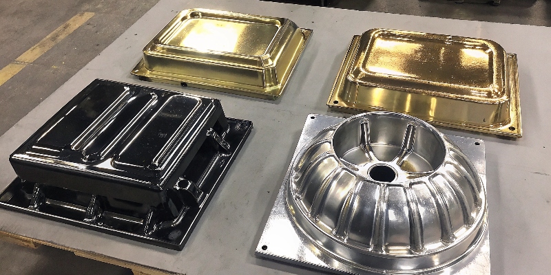 A collection of aluminum die-cast parts with different polished finishes, from matte to mirror-like.