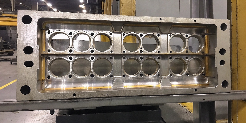 A cross-section of an aluminum die casting showing porosity defects under a microscope