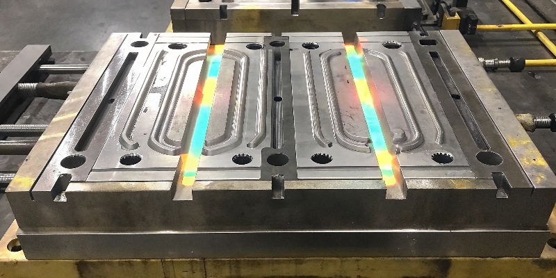 A die casting mold with integrated heating and cooling channels and thermal imaging overlay