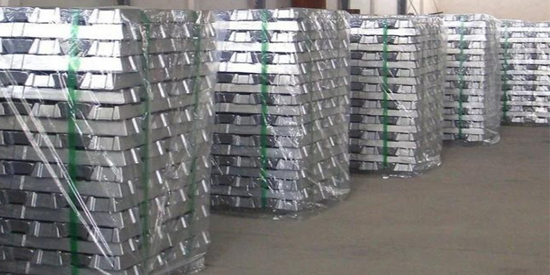 A display of different aluminum alloy ingots with labels like A380, ADC12, and AlSi9Cu3.