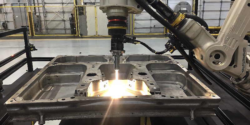 An automated robotic arm using a laser on an aluminum automotive part