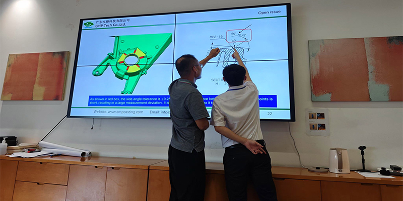 A photo of the EMP Tech team collaborating with a client during a video call, pointing to a 3D model on the screen.
