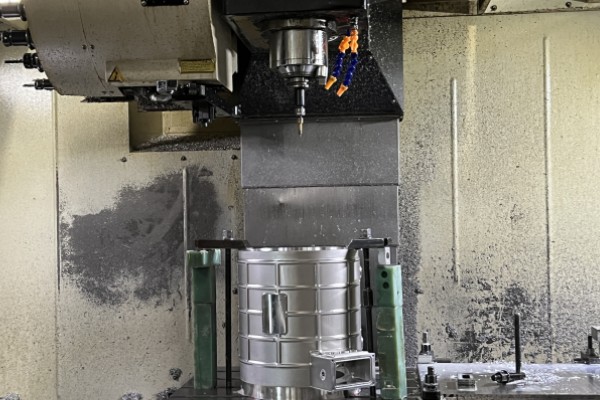 A photo of the EMP Tech factory floor, showing a robotic FSW cell operating near CNC machines and die casting cells