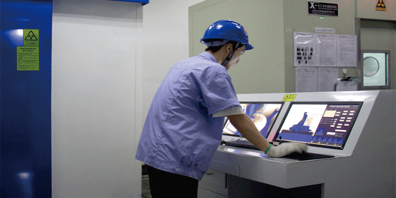 Enhancing Alloy Composition and Material Quality A technician using a spectrometer to test the chemical composition of a molten aluminum sample taken from a furnace.