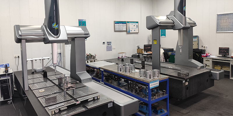 A robotic CMM machine carefully measuring a complex automotive die-cast part to ensure it meets micron-level tolerances.