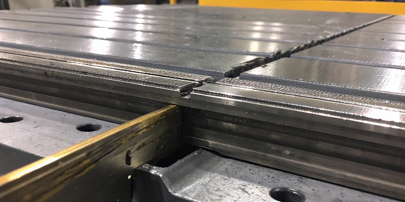 A die-cast part with a visible hot tear crack near a stress concentration point like a sharp corner