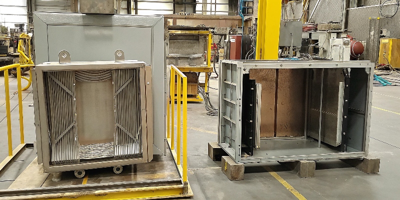 A raw aluminum die-cast enclosure next to a fully assembled and finished power inverter unit