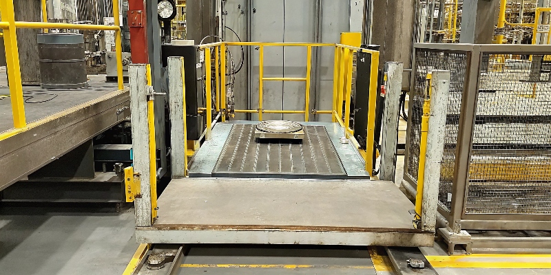 A scale balancing a lightweight aluminum motor housing against a much heavier steel equivalent