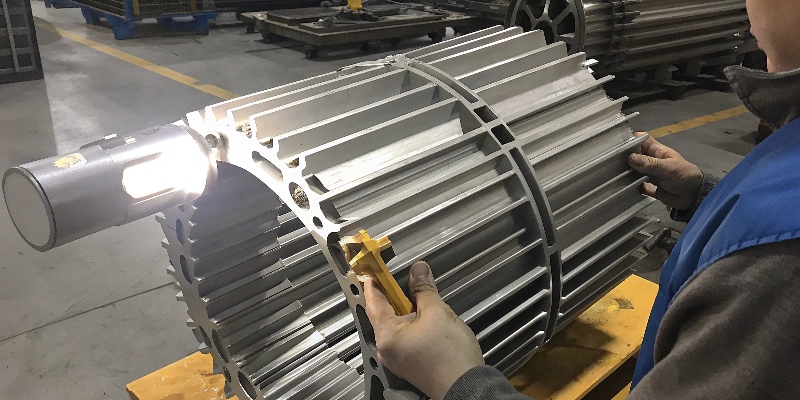 Selecting Aluminum for EV Motor Housings An engineer inspecting a complex aluminum electric motor housing