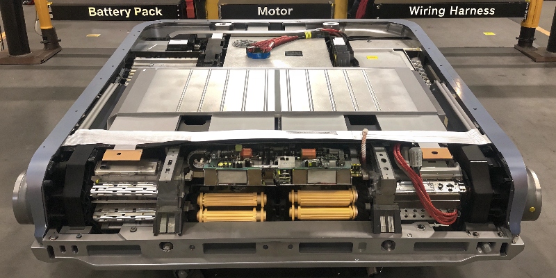 An exploded view of an electric vehicle showing various die-cast aluminum components