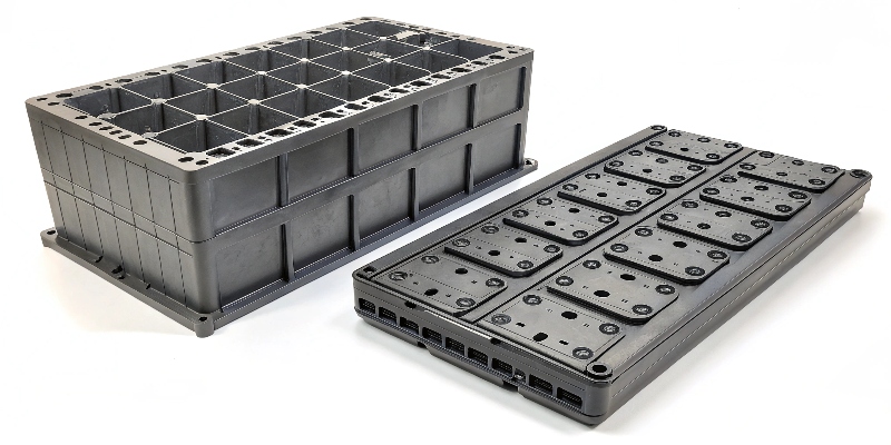 Side-by-side comparison: a multi-part battery tray with many welds vs. a single, large die-cast battery tray