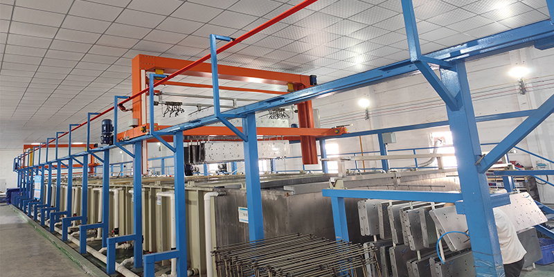 Surface Preparation for Optimal Anodizing A die-cast part being lowered into a bubbling chemical cleaning bath in a clean, professional factory setting.