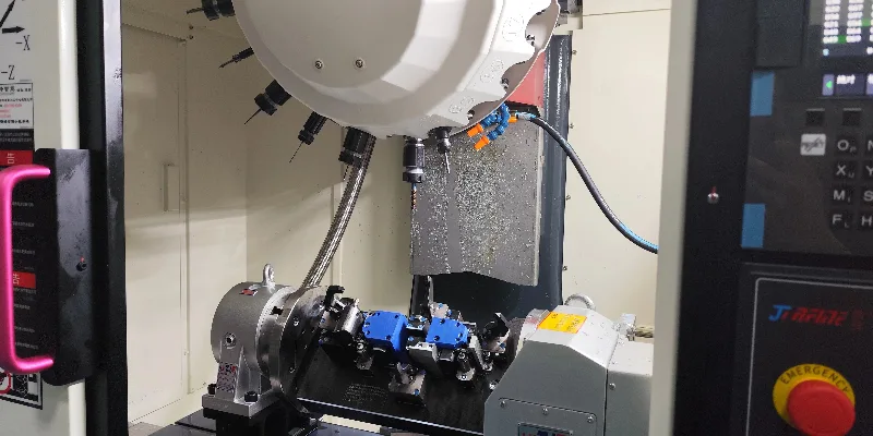 A CNC machine's cutting tool precisely finishing the bearing pocket on a die-cast aluminum motor housing.