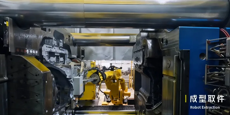 Mega-casting innovation in automotive manufacturing A "Giga Press" in action, with a massive, single-piece aluminum rear underbody of a car being extracted by a robot.