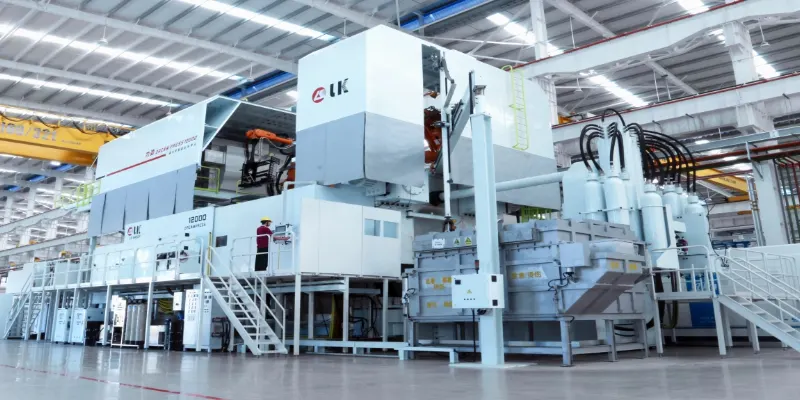 Gigacasting and mega-casting changing vehicle production A massive "Giga Press" die casting machine, the size of a small house, with a newly cast, single-piece rear underbody of a car being extracted by a giant robot.