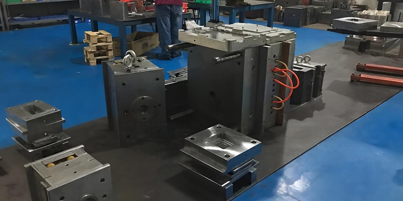 Applying Heat Treatments and Protective Coatings A die-casting mold component glowing orange inside a vacuum heat treatment furnace.
