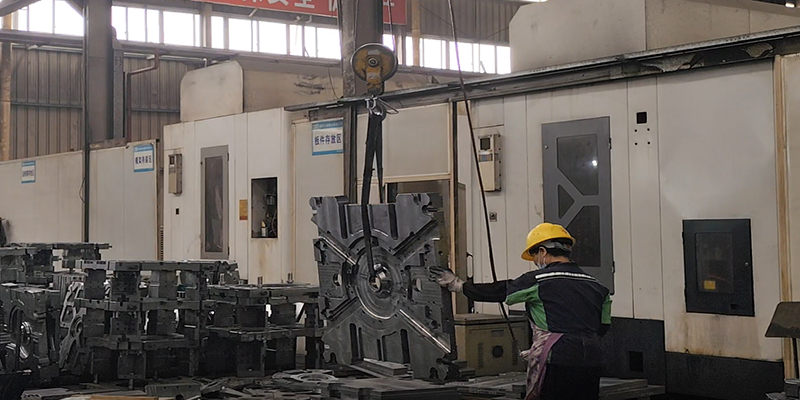 Adopting Regular Maintenance and Manufacturing Best Practices A technician following a checklist while performing routine maintenance on a die-casting mold mounted in a press.