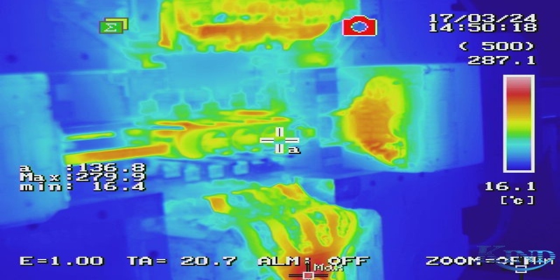 Implementing Proper Preheating and Temperature Management An operator using an infrared thermometer to check the surface temperature of a mold being preheated with cartridge heaters.