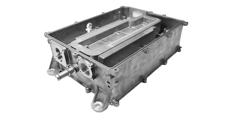 A cutaway view of an aluminum die-cast motor housing showing integrated cooling fins and fluid channels.