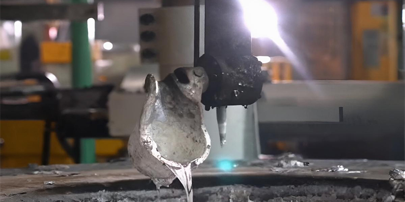 A high-speed photograph of molten aluminum being injected into a die casting machine, emphasizing precision and power.